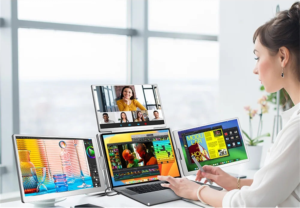 Person using a laptop with multiple display extensions in a bright room.