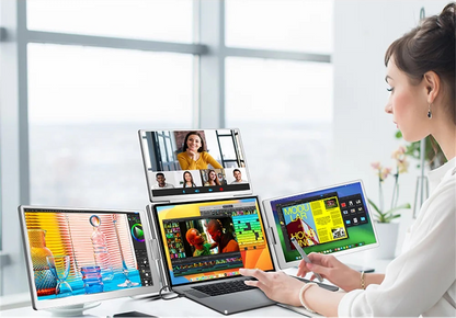 Person using a laptop with multiple display extensions in a bright room.