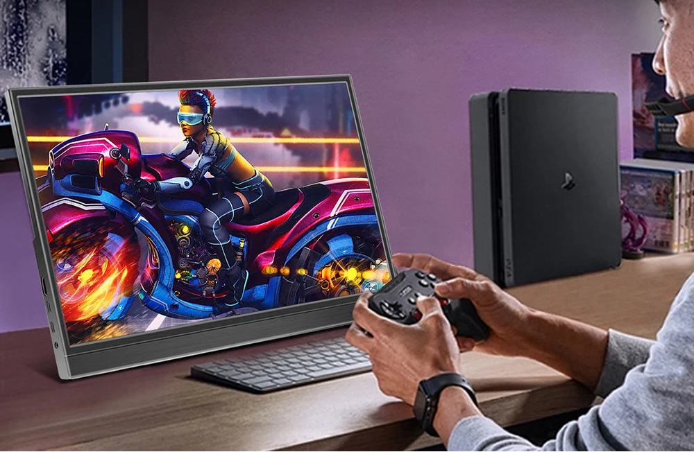 Person playing a racing game on a laptop with gaming consoles in the background